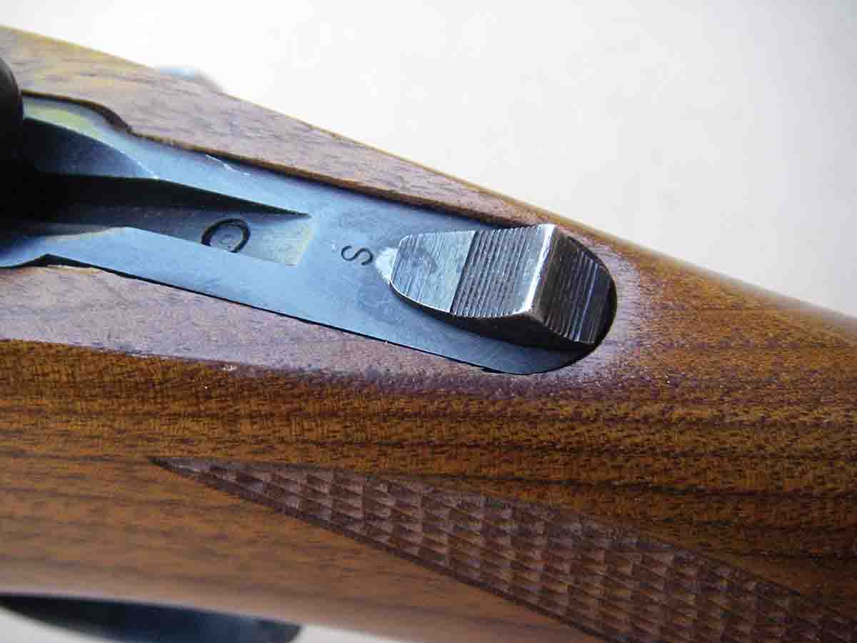 All M77 rifles featured a sliding tang safety that locked the bolt handle down when set on “safe.” By the early 1980s the design was changed to allow the bolt handle to be lifted when the safety is in the “on” position.